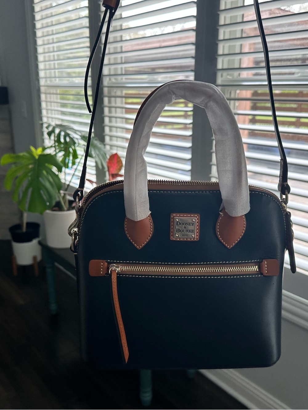 sleek silhouette and domed satchel-classic choice for everyday use.